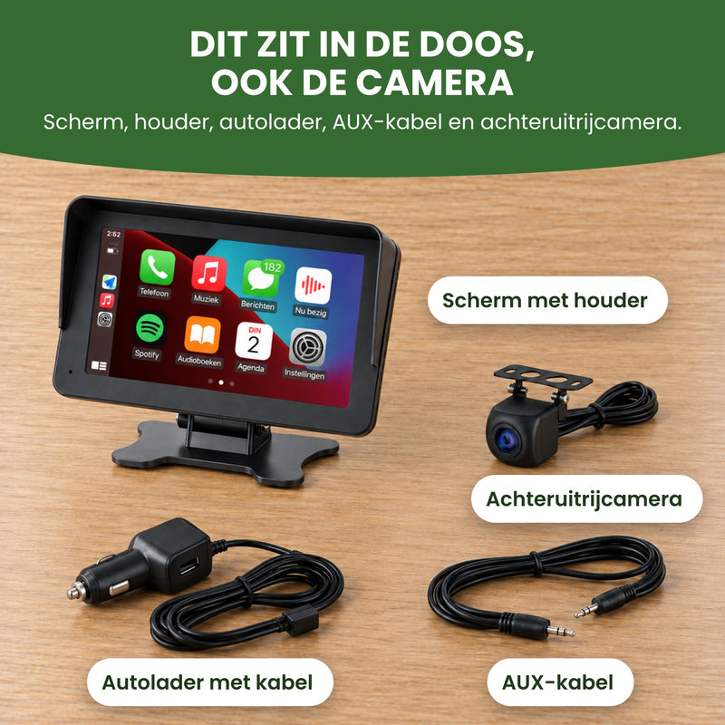 DriveMate One met houder, achteruitrijcamera, autolader met kabel en AUX-kabel op een tafel: dit zit in de doos, ook de camera