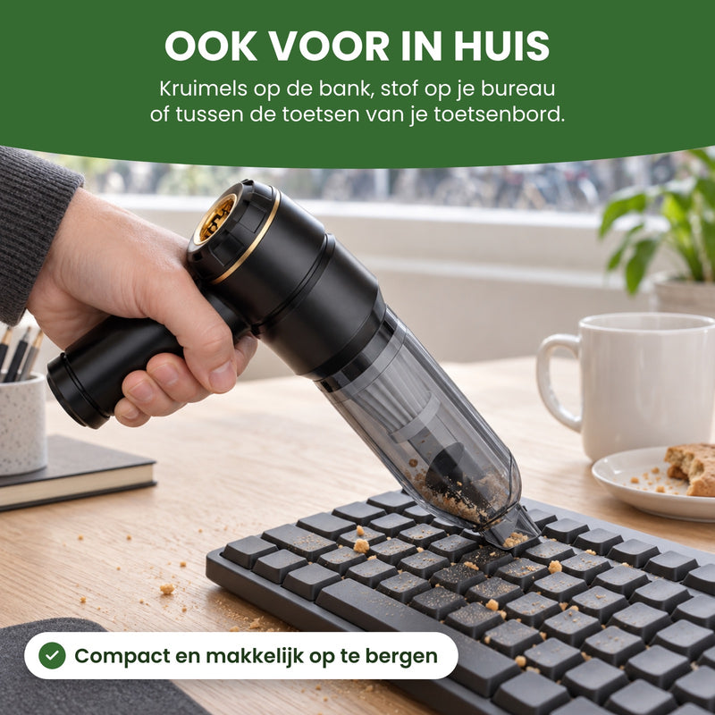 Hand zuigt met de kruimeldief kruimels tussen de toetsen van een toetsenbord op een bureau bij het raam: ook voor in huis