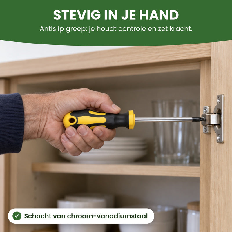 Hand met een schroevendraaier uit de set aan het scharnier van een keukenkastje: stevig in je hand door de antislip greep