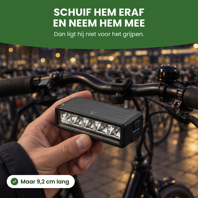 Voltura fietslamp in de hand bij een fietsenstalling: schuif hem eraf en neem hem mee, 9,2 cm lang
